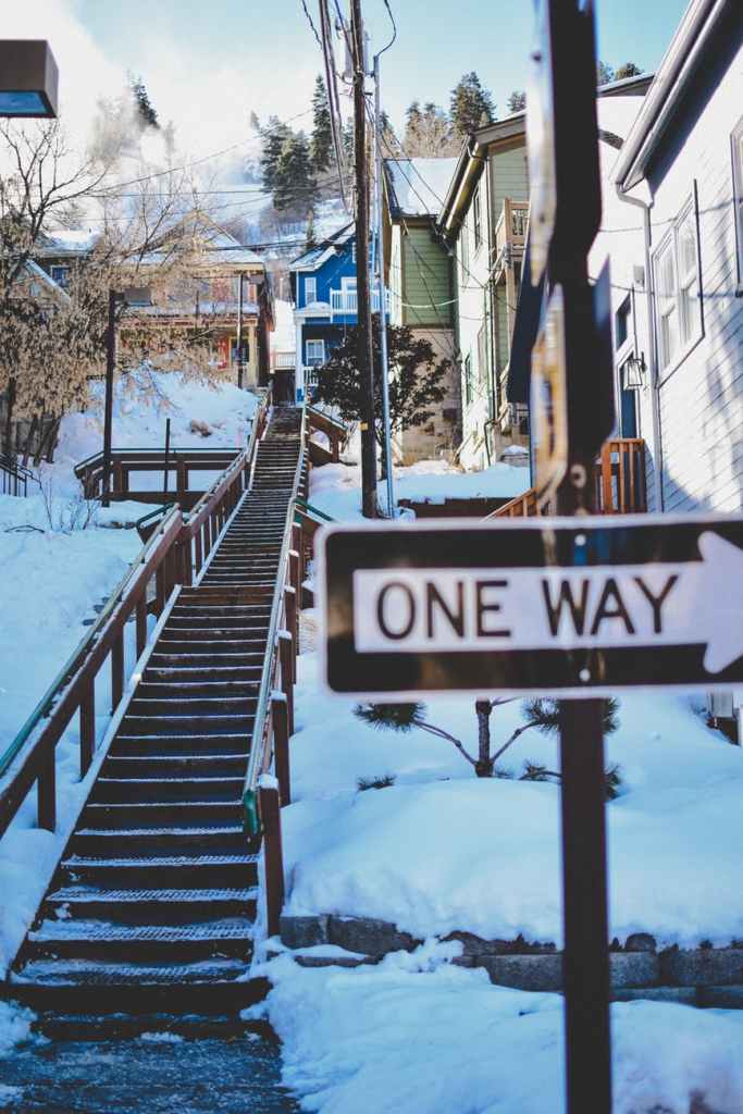 one way road sign and empty staircase